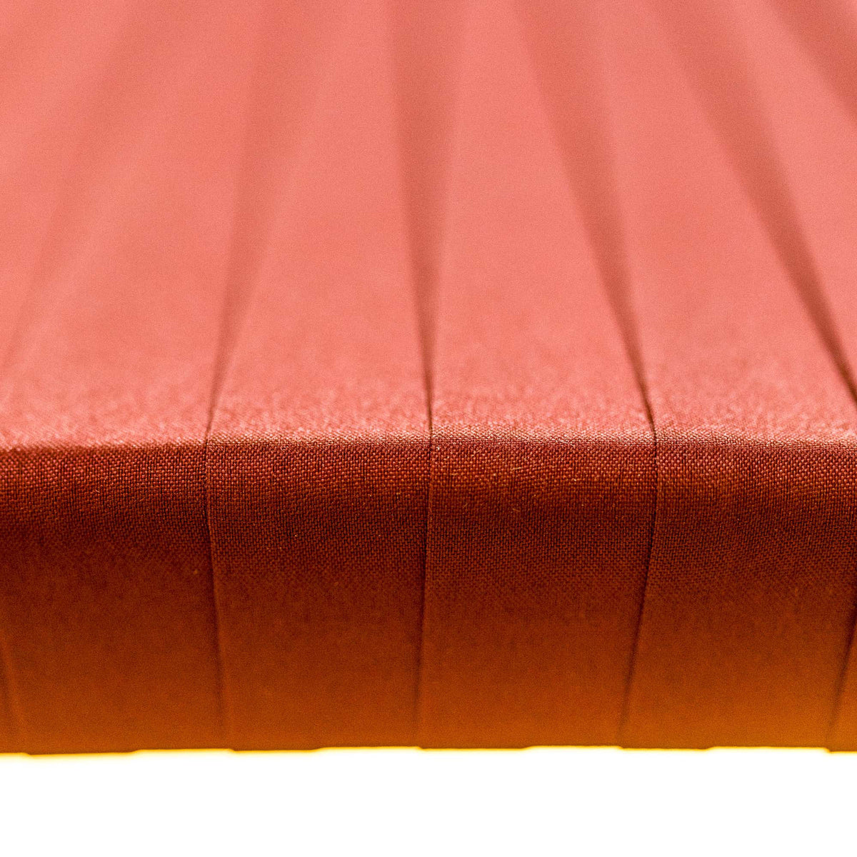 Close-up of a red fabric surface with pleated texture