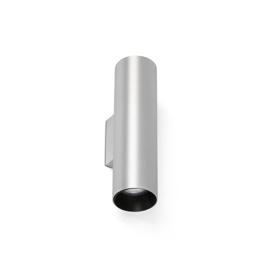 A modern cylindrical wall sconce in a brushed silver finish with a black interior, shown against a plain white background.