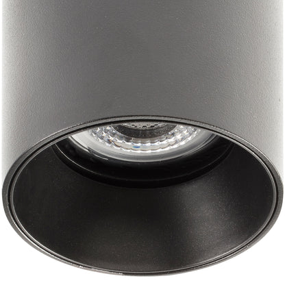 Black cylindrical spotlight with a clear lens on a white background