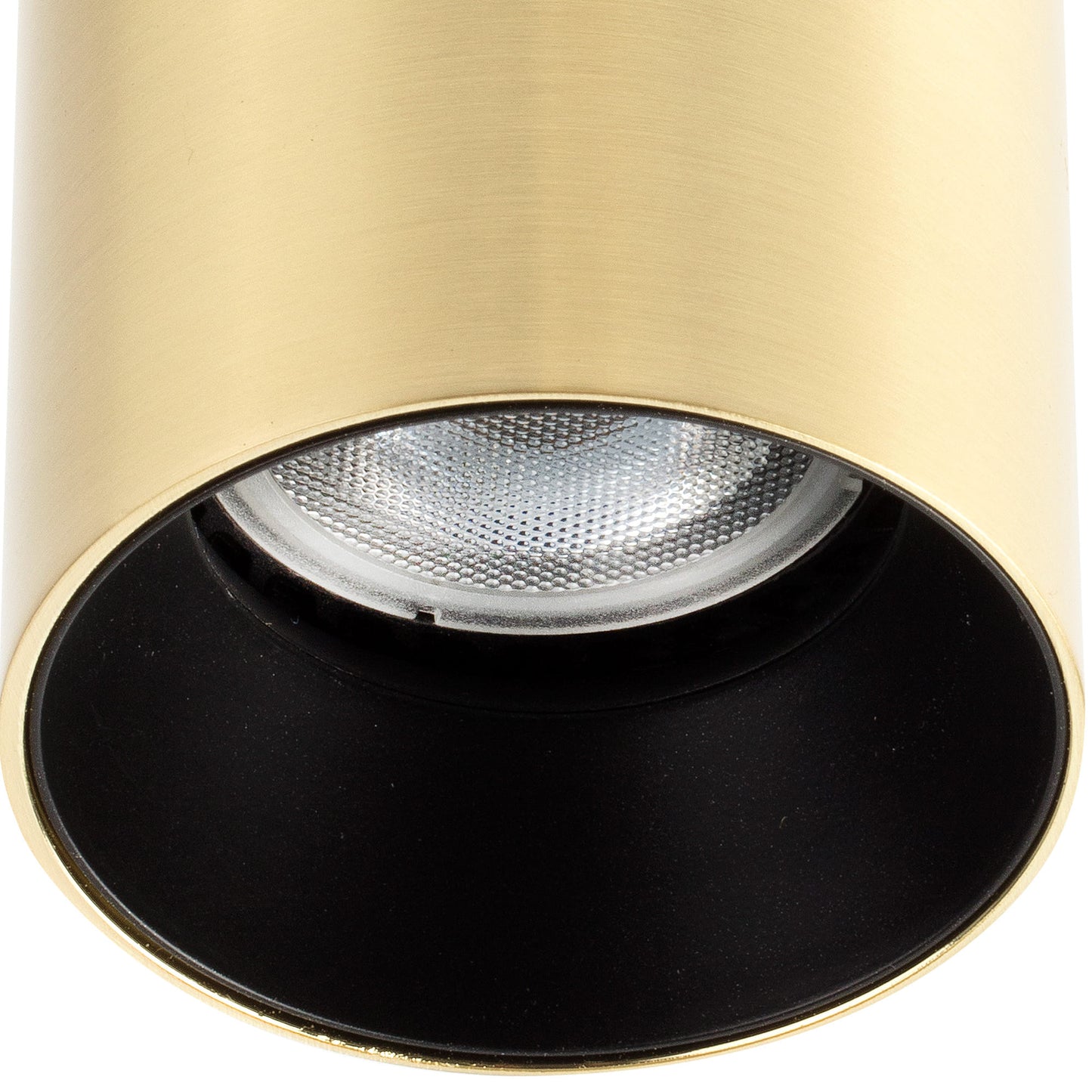 Close-up of a gold and black spotlight with a white bulb inside.