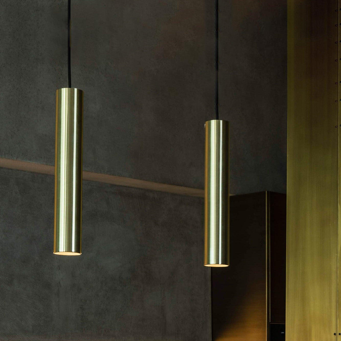 Modern kitchen with pendant lights and a sink.