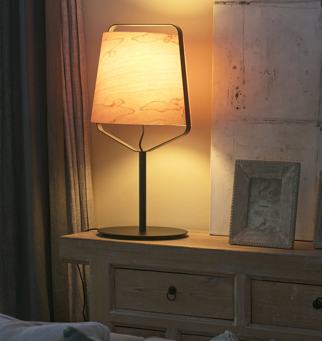Napoleon III style sideboard with lamp and framed pictures in a cozy room.