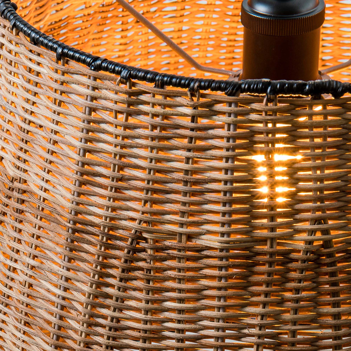 Close-up of a wicker lampshade with a light bulb inside