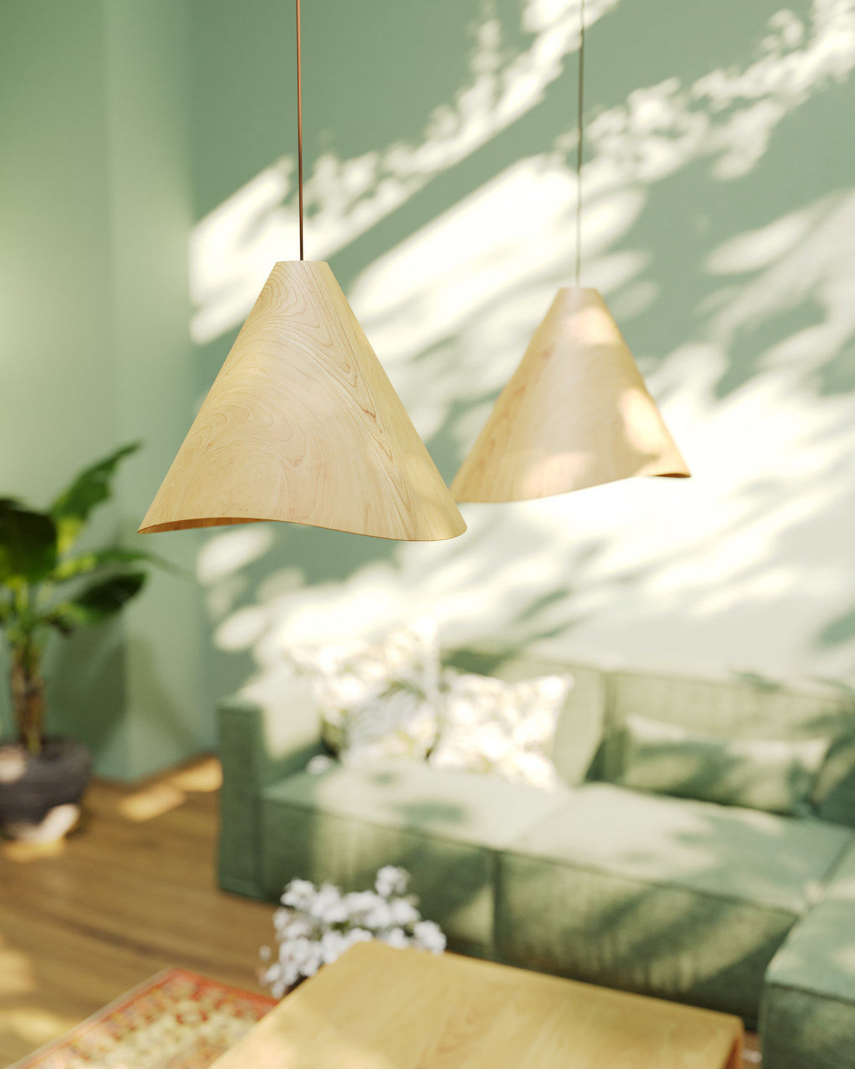 The Sakura wooden modern pendant lights featuring natural oak finishes hanging in a living room interior with sunlight and leafy shadows. Available to buy at the VXR Space store.