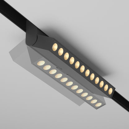 Black rotatable Points magnetic track luminaire demonstrating adjustability and mobility on a track against a clean background.