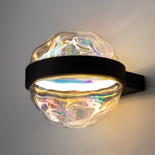 Decorative wall light with iridescent glass shade on a gray background