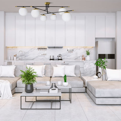 Modern living room with gray sectional sofa, coffee table, and kitchen in the background.