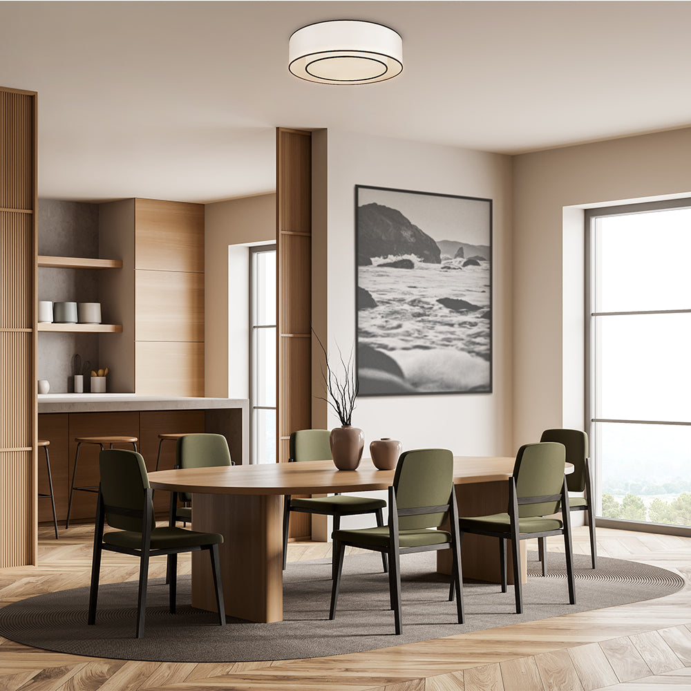 Modern dining room with wooden table and chairs, large windows, and a mountain landscape painting.
