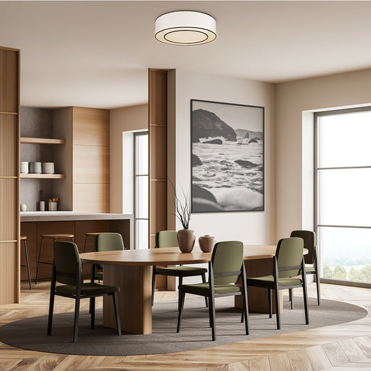 Modern dining room with wooden table and chairs, large windows, and a mountain landscape painting.