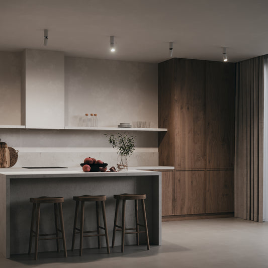 Modern kitchen with wooden cabinets, gray countertops, and ceiling light