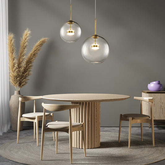 Dining room with wooden table and chairs, glass pendant lights, and pendant lamps.