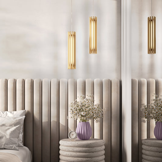 Modern bedroom with beige headboard, gold wall lights, and decorative vases.
