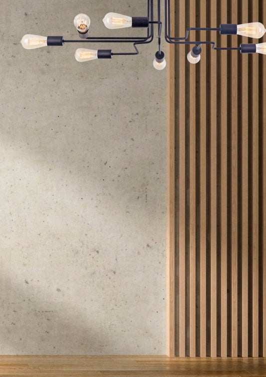 Modern chandelier with white bulbs on a concrete wall and wooden floor.