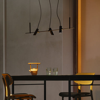 Modern dining area with a black table and chairs, featuring a minimalist light fixture outdoor
