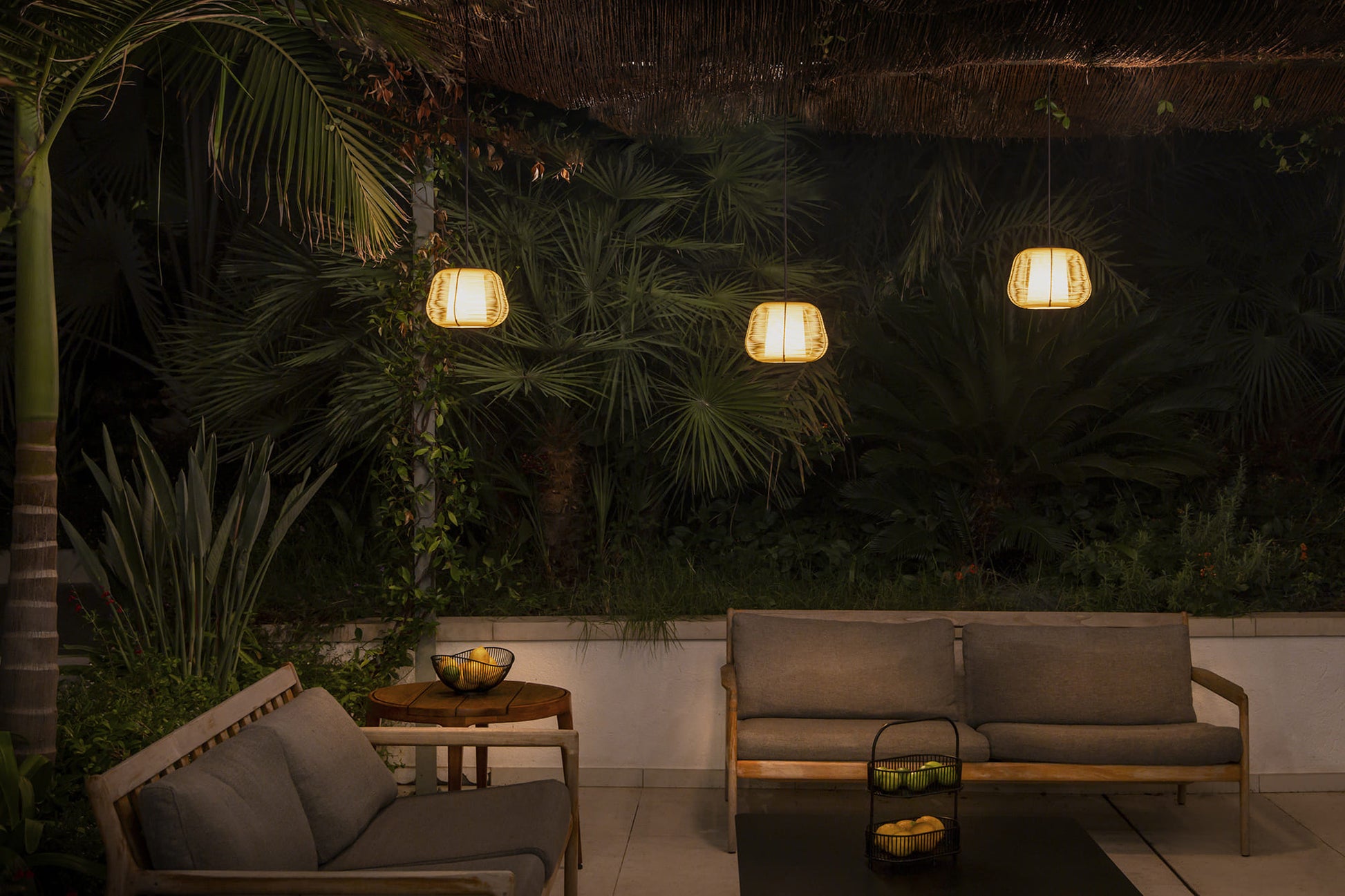 Outdoor patio area with furniture and lighting at night