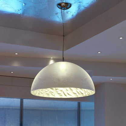 Modern dining room with a large pendant light fixture.