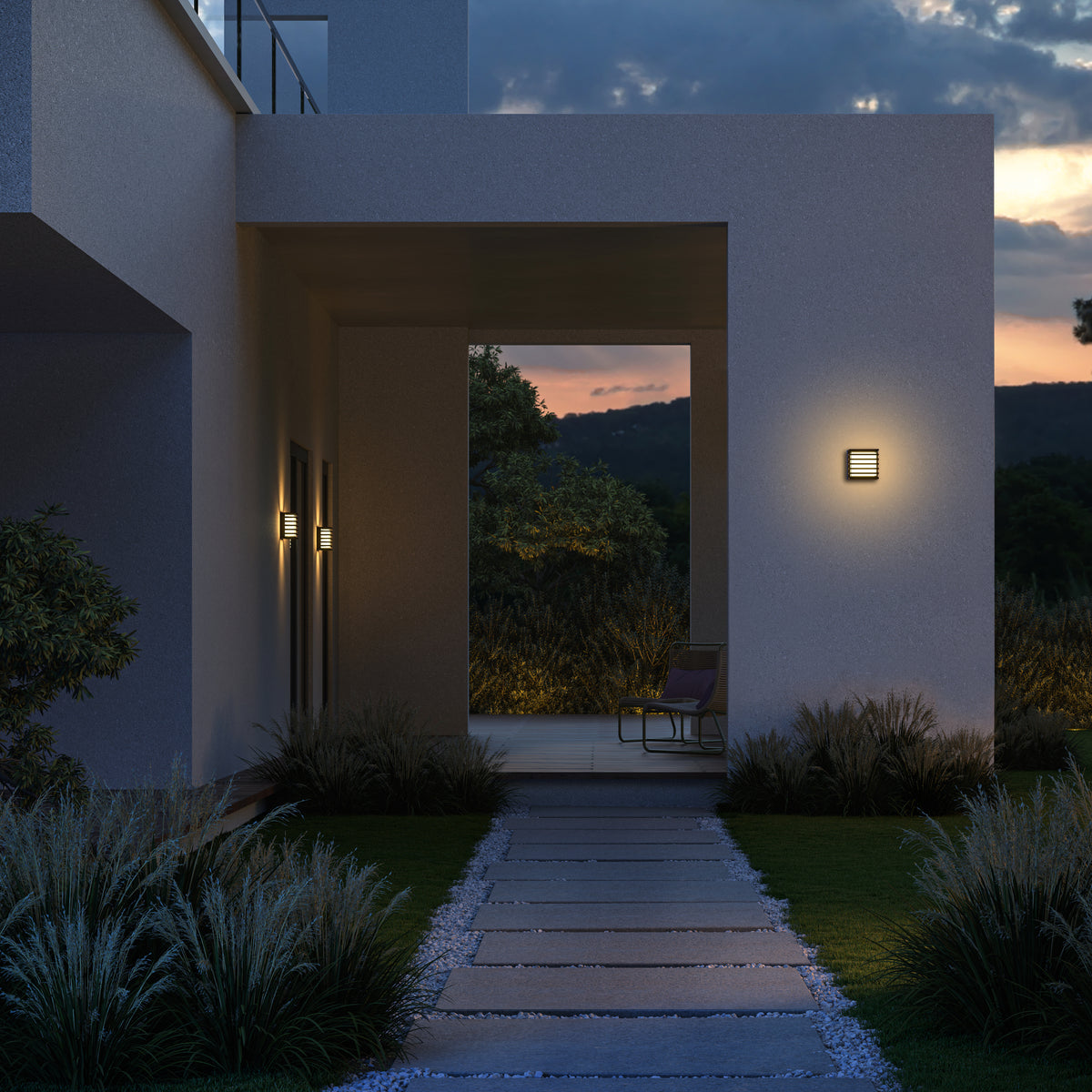 Modern house exterior with illuminated pathway and wall lights at dusk.