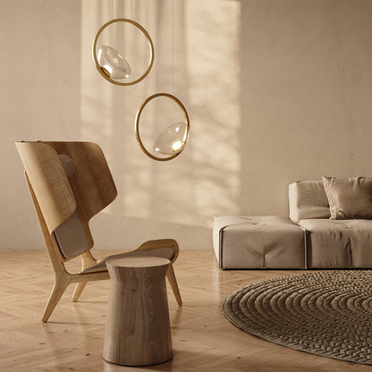 Modern living room with wooden chair, round stool, and sofa under hanging pendant lights.