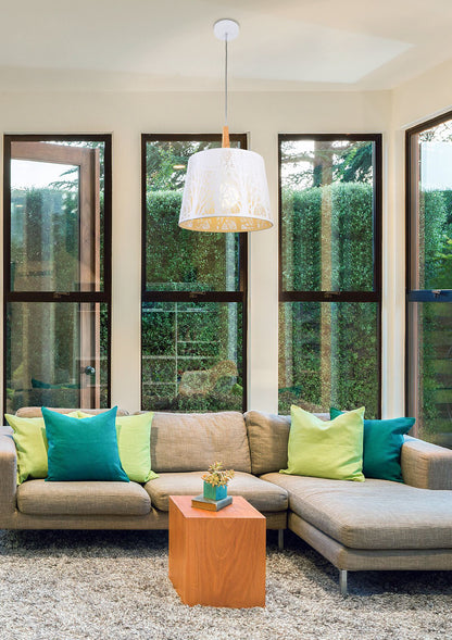 Modern living room with a beige sectional sofa, colorful pillows, and a wooden side table.