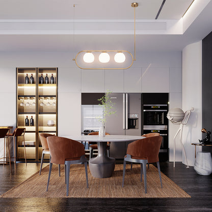 Modern kitchen with dining area featuring a table and chairs.