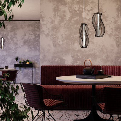 Modern restaurant interior with red booth, white table, and decorative lamps.