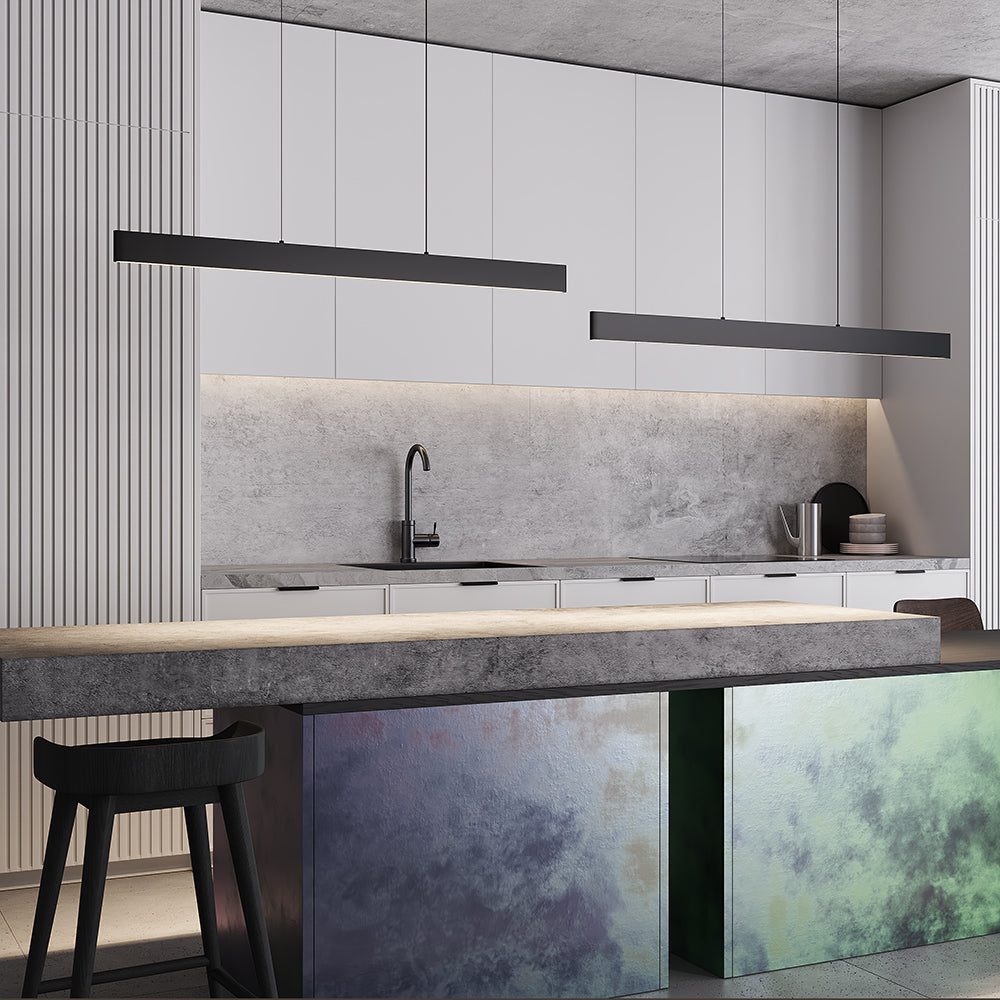 Modern kitchen with gray backsplash, white cabinets, and pendant lamp