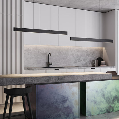 Modern kitchen with gray backsplash, white cabinets, and pendant lamp