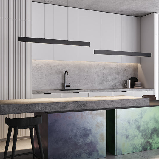 Modern kitchen with gray backsplash, white cabinets, and pendant lamp