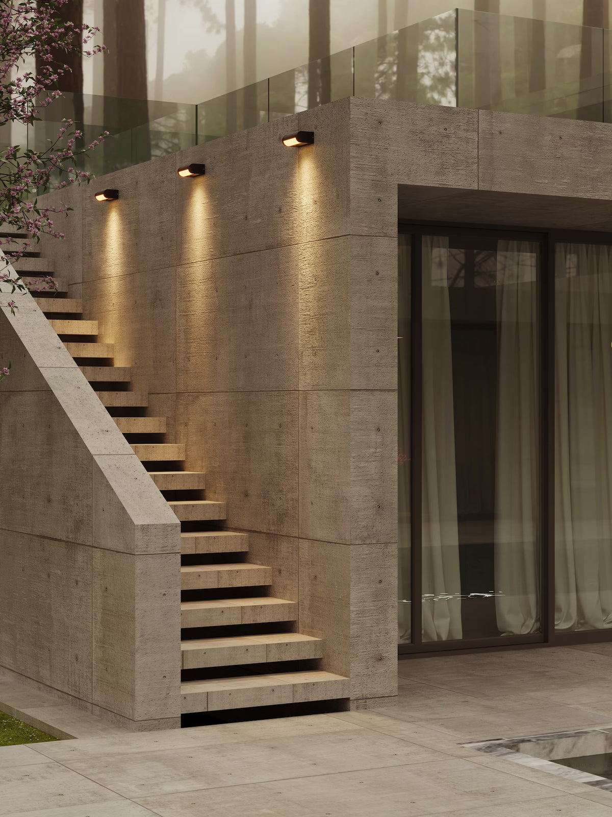 The Solden matte black LED exterior wall sconces mounted on an architectural concrete facade above outdoor stone steps. Available to buy at the VXR Space store.