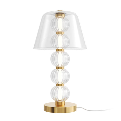 Table lamp with clear glass shades and gold base on a white background