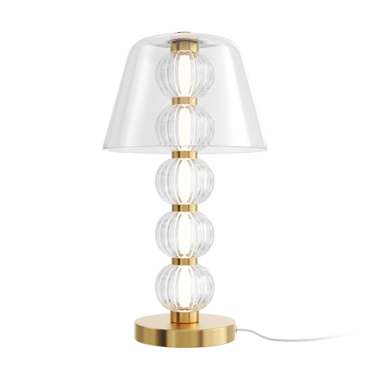 Table lamp with clear glass shades and gold base on a white background