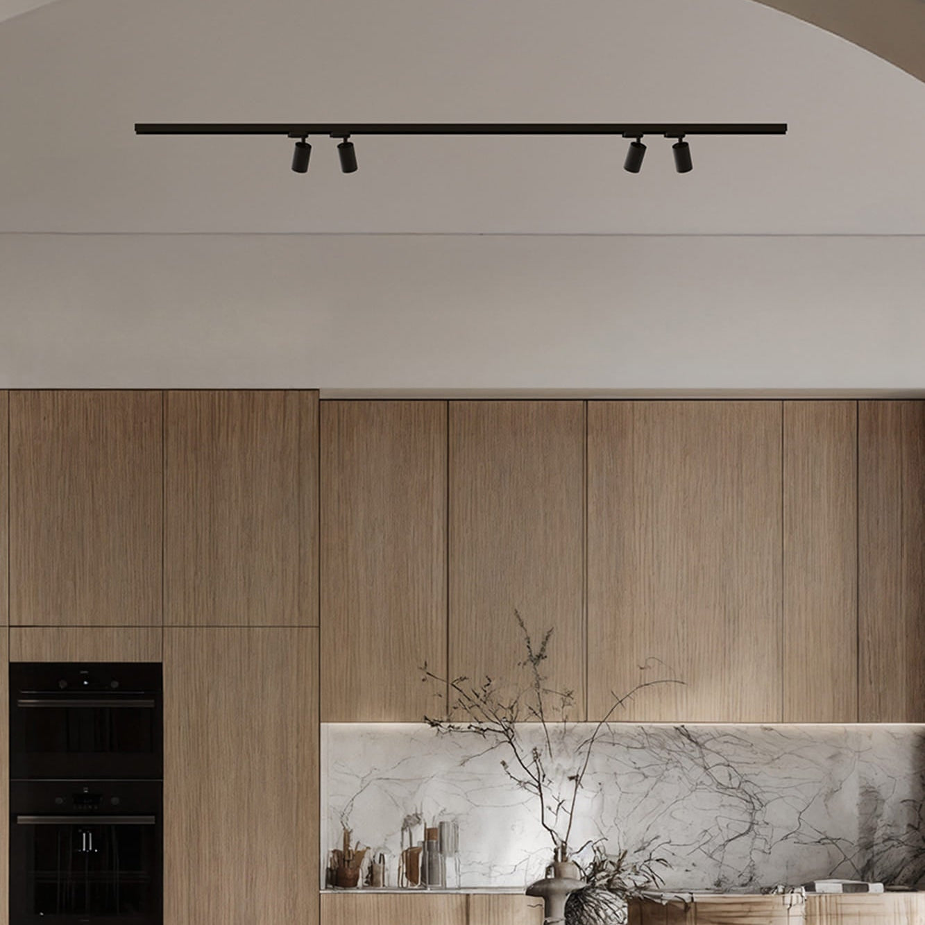 Modern kitchen with wooden cabinets, marble island, and track lighting