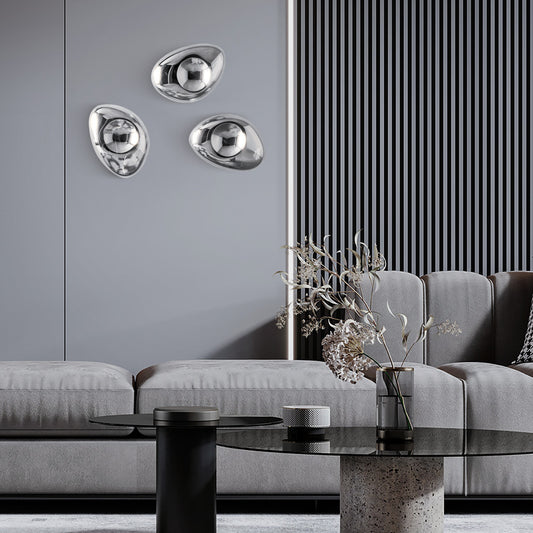 Modern living room with gray sofa, decorative wall art, and wall lamp